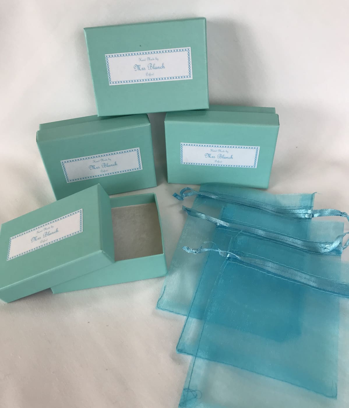 Glass pendants in organza pouches and gift boxes