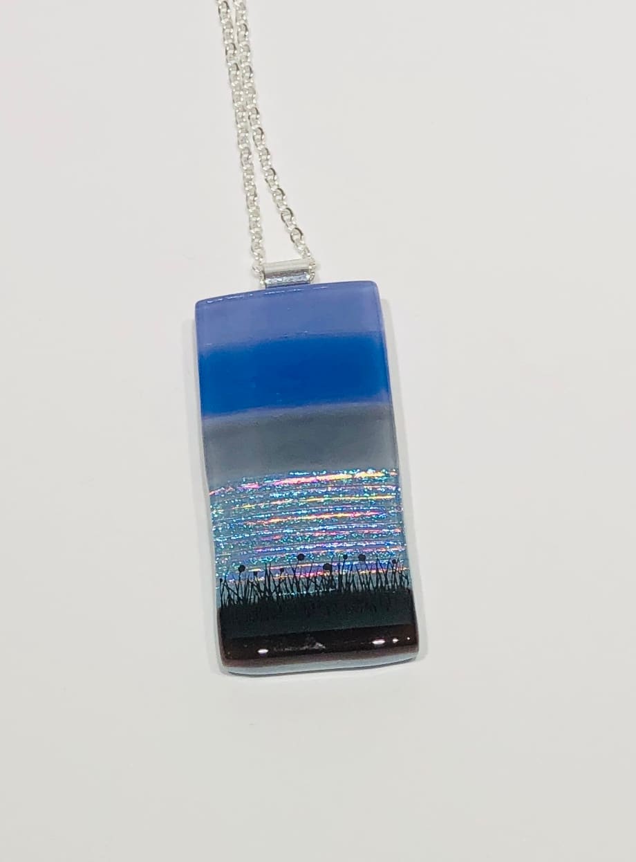 Fused glass pendant in blue tones on a silver chain